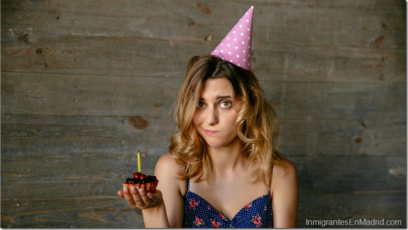 Pretty girl with frustrated face holds a cupcake