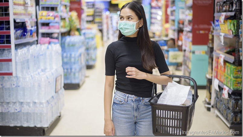 woman with face mask is shopping clothes in Shopping center 